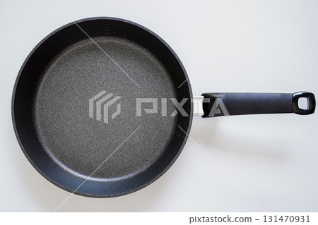 Aerial view of a new frying pan on a white background Aerial view of a new frying pan on a white background 131470931