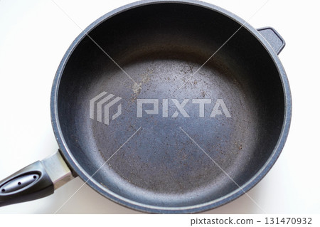 An old frying pan with peeling Teflon coating An old frying pan with peeling Teflon coating 131470932