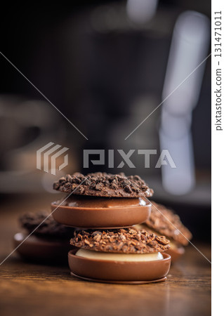 Sweet chocolate pralines. Chocolate candies on wooden table. 131471011