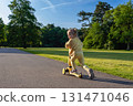 Scooter and kid. Toddler outdoor riding. Fun yellow play childhood freedom. 131471046
