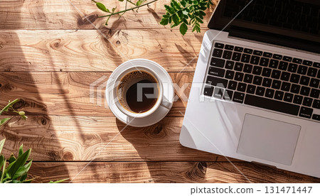 Coffee and laptop on a wooden table / Lifestyle material depicting a natural work scene Coffee and laptop on a wooden table / Lifestyle material depicting a natural work scene 131471447