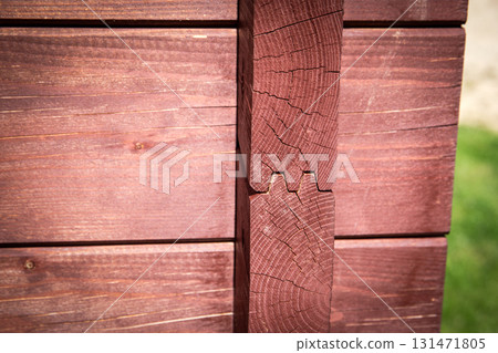 Close-Up of Interlocking Timber Corner in Sunlight on Wooden Cabin Wall. 131471805