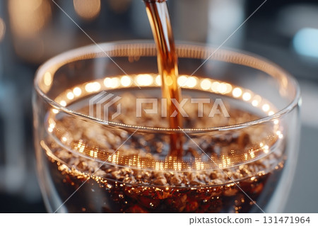 Coffee being poured into a clear glass cup with soft lighting in a cozy setting Coffee being poured into a clear glass cup with soft lighting in a cozy setting 131471964