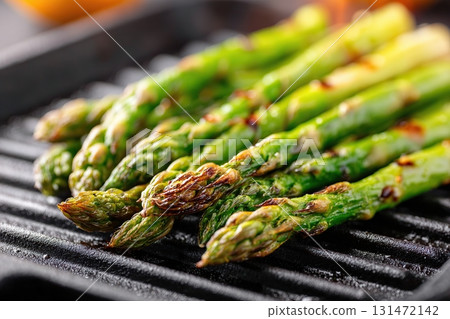 Grilled asparagus spears cooking on a grill pan for a delicious side dish 131472142