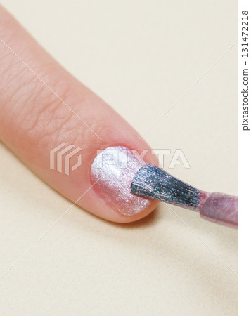 manicure in a beauty salon or at home, a woman paints her nails. manicure in a beauty salon or at home, a woman paints her nails. 131472218