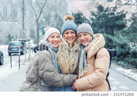 Three cheerful young adult women friend walk Magdeburg street old european uk german town city street enjoy having fun laughing cold winter day together. Female persons friendship celebration weekend Three cheerful young adult women friend walk Magdeburg street old european uk german town city street enjoy having fun laughing cold winter day together. Female persons friendship celebration weekend 131472260