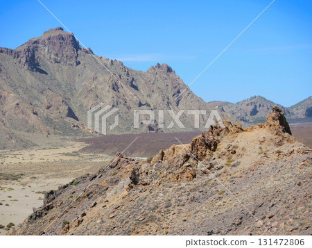 Rugged Volcanic Landscape with Rocky Mountains under Clear Blue Sky in Teide National Park, Tenerife Rugged Volcanic Landscape with Rocky Mountains under Clear Blue Sky in Teide National Park, Tenerife 131472806