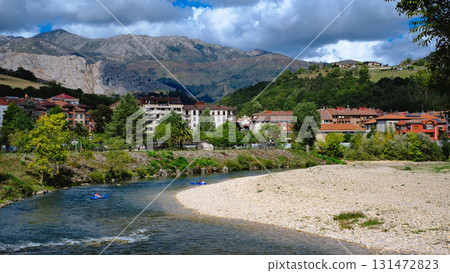 A picturesque video of the town of Arriondas in Asturias, Spain, with a tranquil river flowing through it. 131472823