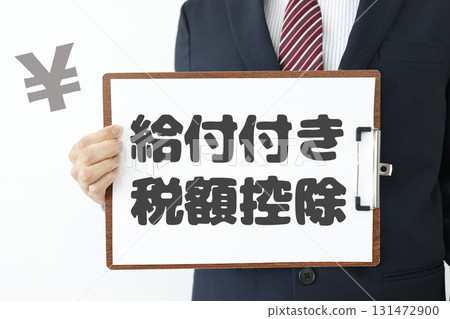 An image of a man in a suit holding a paper explaining the tax credit with benefits system. 131472900