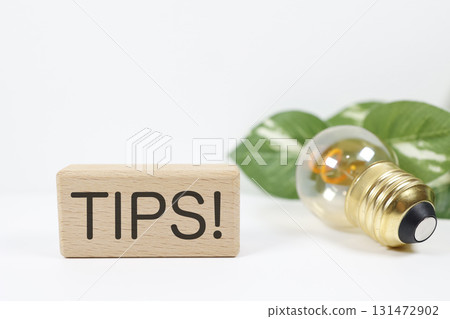 Light bulb and TIPS! Ideas and information expressed with letter blocks stock photo Light bulb and TIPS! Ideas and information expressed with letter blocks stock photo 131472902