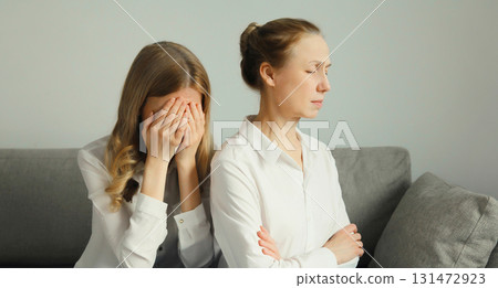 Upset offended caucasian two women, mature mother or sister and adult daughter together at home 131472923