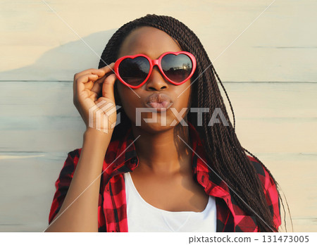 Happy young African woman in red heart shaped glasses, beautiful black girl in sunglasses 131473005