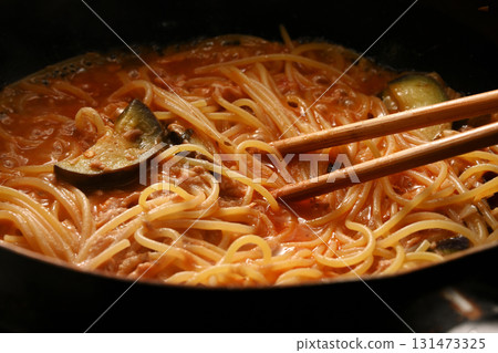 Cooking eggplant and tuna pasta in tomato sauce 131473325