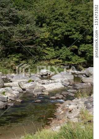 A river flowing through green mountains A river flowing through green mountains 131473382