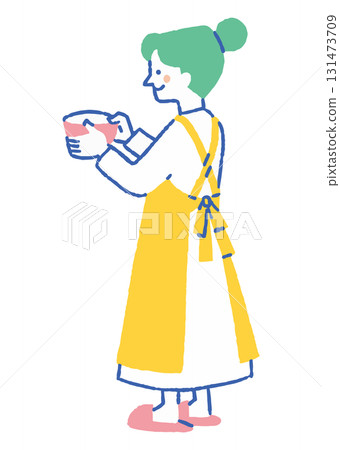 A woman making sweets in an apron_Color 131473709