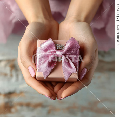 Woman hands holding pink gift satin ribbon, shopping Valentines, New Year, Mothers, Christmas 131473945