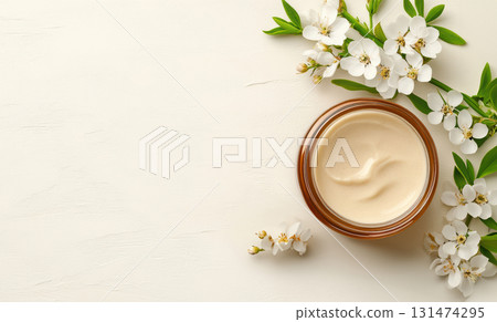 Jar of cream made from natural ingredients with hexagonal texture glows linden blossom, wooden spoon lying on table with spoonful acacia flowers , emphasizing theme homemade and organic skin care 131474295