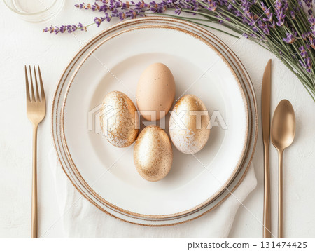 Happy Easter. Elegant top view, layout, minimalist style, Easter decorated table with golden eggs and lavender bouquet arranged on napkin with matching cutlery and glassware. Happy Easter. Elegant top view, layout, minimalist style, Easter decorated table with golden eggs and lavender bouquet arranged on napkin with matching cutlery and glassware. 131474425