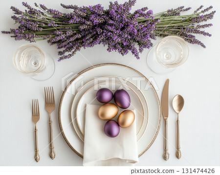 Luxury Happy Easter. Elegant top view, layout, minimalist style, Easter decorated table with golden eggs and lavender bouquet arranged on napkin with matching cutlery and glassware. Luxury Happy Easter. Elegant top view, layout, minimalist style, Easter decorated table with golden eggs and lavender bouquet arranged on napkin with matching cutlery and glassware. 131474426