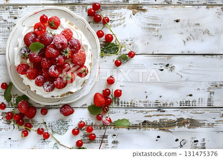 summer dessert topped red berries, placed on a rustic white wooden background 131475376
