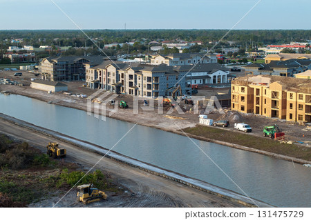 Wooden apartment buildings under construction in new developing suburban area. Development of residential housing in Florida suburbs. Real estate market in the USA 131475729