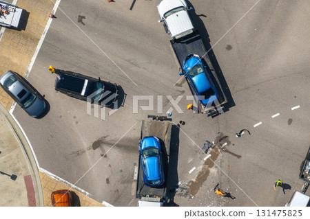 Tow truck loading crashed car on accident site. Emergency services personnel and vehicles responding to vehicle crash on American street 131475825