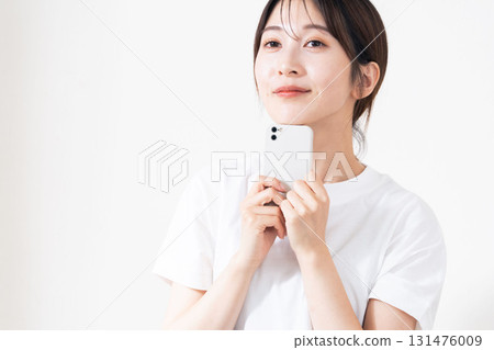A woman using a smartphone A woman using a smartphone 131476009