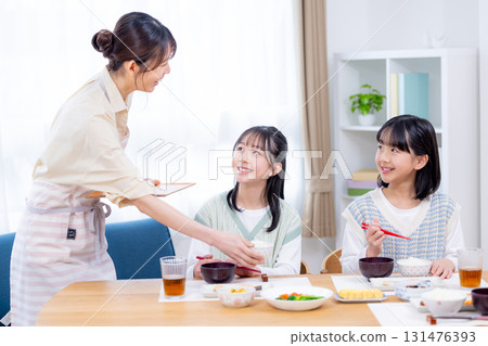 Family breakfast girl eating rice 131476393