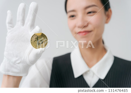 A woman appraising precious metals A woman appraising precious metals 131476485