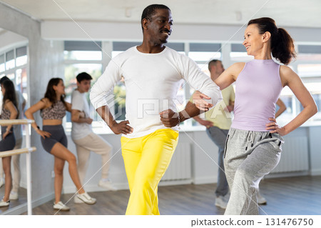 Couple adult woman and man dancing twist 131476750