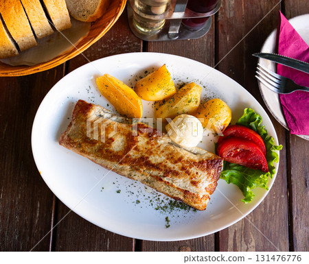 Steak served with boiled potatoes and tomatoes. Cuisine of Bosnia and Herzegovina Steak served with boiled potatoes and tomatoes. Cuisine of Bosnia and Herzegovina 131476776