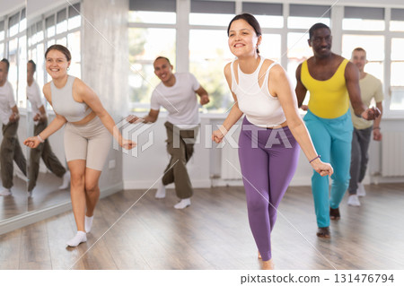 Young Asian woman practicing energetic dance at group class 131476794
