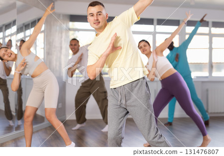 Young man practicing hip-hop dance in training hall Young man practicing hip-hop dance in training hall 131476807
