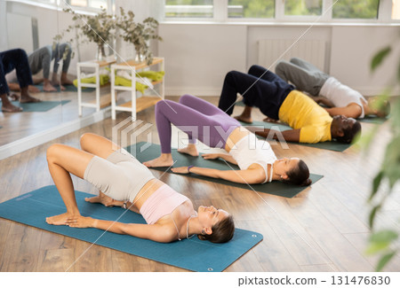 Group of men and women doing pilates in studio 131476830