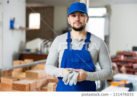 Portrait of a builder standing on a construction site indoors Portrait of a builder standing on a construction site indoors 131476835
