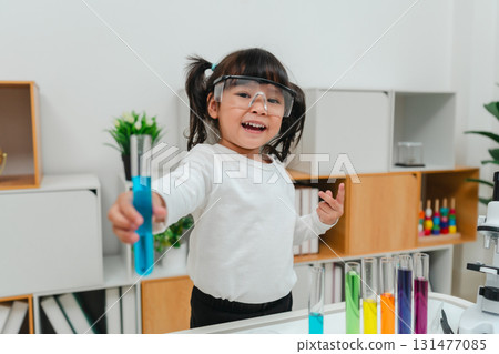 happy toddler girl scientist learning science with test tube and beaker 131477085
