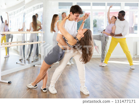 Expressive young couple enjoying impassioned merengue in dance class Expressive young couple enjoying impassioned merengue in dance class 131477171