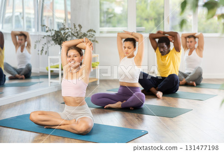 Group of men and women doing yoga in studio 131477198