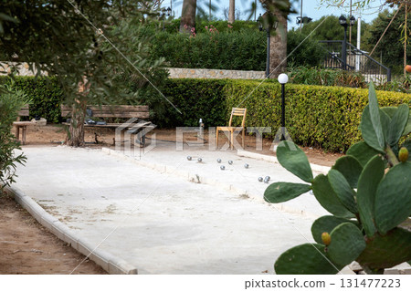 Petanque court with ball on sandy surface 131477223