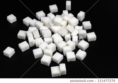 Cubes of white refined sugar on a black background 131477270