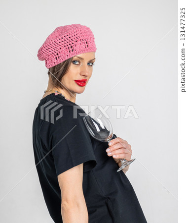 Portrait of beautiful woman in pink beret and black T-shirt with wine glass in French style. Bright makeup with red lipstick. Vertical photo. High quality photo Portrait of beautiful woman in pink beret and black T-shirt with wine glass in French style. Bright makeup with red lipstick. Vertical photo. High quality photo 131477325