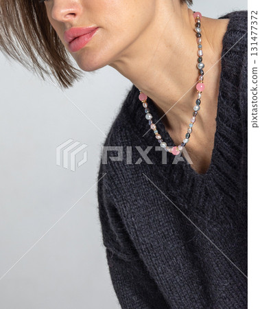 Neck of young woman close-up on grey background. Studio photography. Vertical photo. High quality photo Neck of young woman close-up on grey background. Studio photography. Vertical photo. High quality photo 131477372