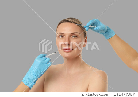 A professional administers cosmetic injections for facial beauty A professional administers cosmetic injections for facial beauty 131477397