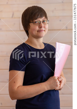 Business woman in glasses holding files and pen in her hands. High quality photo Business woman in glasses holding files and pen in her hands. High quality photo 131477675
