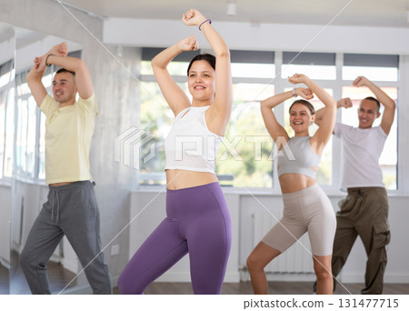 Young Asian woman practicing energetic dance at group class Young Asian woman practicing energetic dance at group class 131477715