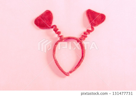Valentine's Day art composition with red headband heart-shaped on pink surface. Valentine celebration concept. Flat lay, top view, copy space, greeting card Valentine's Day art composition with red headband heart-shaped on pink surface. Valentine celebration concept. Flat lay, top view, copy space, greeting card 131477731