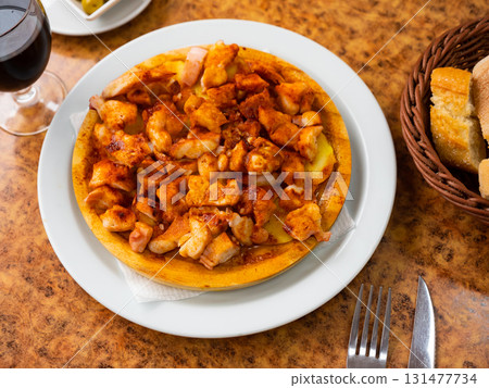 Cooked octopus with potatoes 131477734