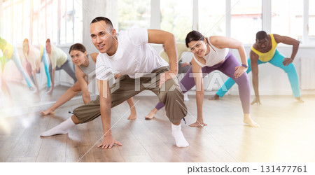 Group of people warming up before dance class Group of people warming up before dance class 131477761