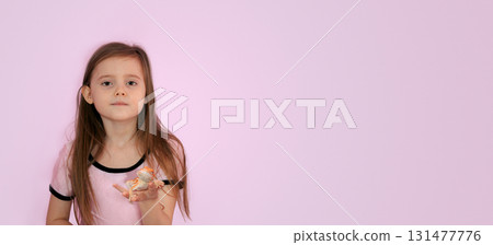Portrait of pretty girl with Red bearded Agama iguana on pink background. Little child playing with reptile. Selective focus. Banner, copy space. High quality photo Portrait of pretty girl with Red bearded Agama iguana on pink background. Little child playing with reptile. Selective focus. Banner, copy space. High quality photo 131477776