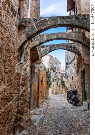 Street view of old town of Rhodes, Greece. Paved roads and pavements with colorful houses and fragrant flowers. High quality photo Street view of old town of Rhodes, Greece. Paved roads and pavements with colorful houses and fragrant flowers. High quality photo 131477807